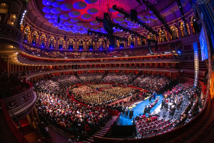 A fisheye lens shot of the entire interior of the Royal Albert Hall while students are processing up to the stage to graduate