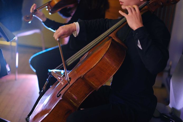 Closeup of hands playing cello