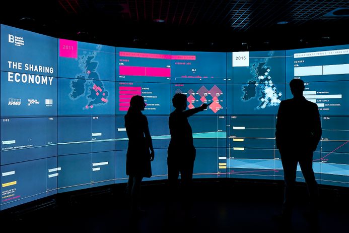 People interacting with the Data Science Institute screen