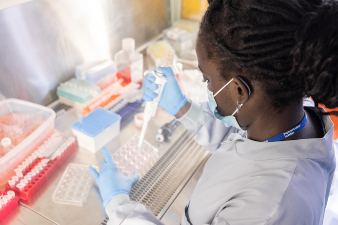 Dr Joy Nagawesi prepares samples in a lab