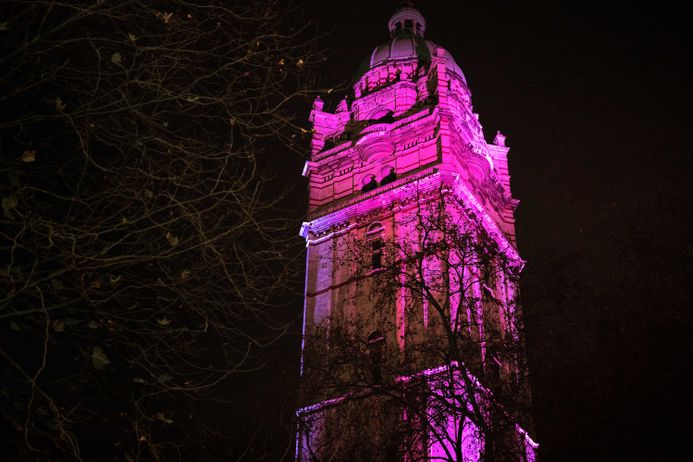 Top of tower building in purple light at night