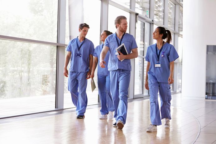 A picture of doctors and nurses walking down a corridor