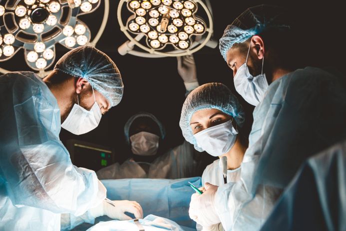 A picture of surgeons operating on a patient