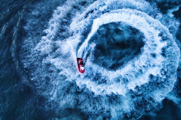 a drone shot of a speedboat on the sea
