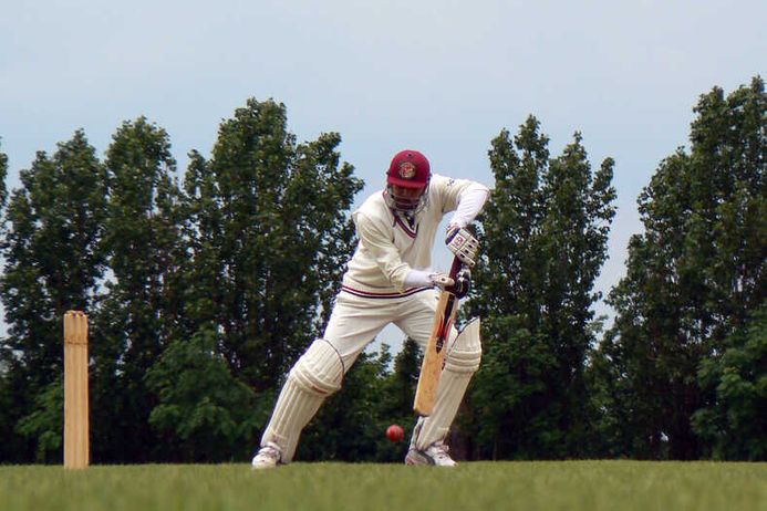 Cricket player at bat just missing the hit