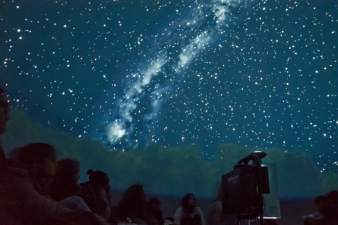 Students inside Outreach planetarium