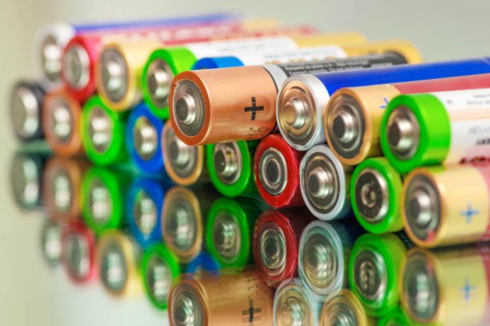 two rows of stacked AA batteries in various colours
