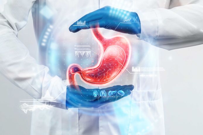 Electronic image of stomach held between two hands of white lab coated person