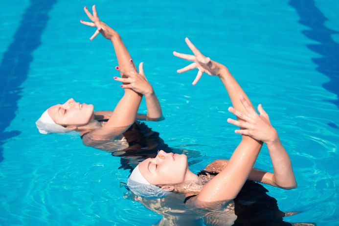 Synchronized swimming duet performing their routine