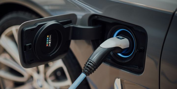 A charger inserted into an electric vehicle charging port