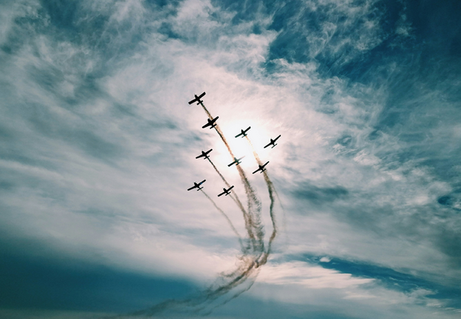 Planes with contrails flying in formation