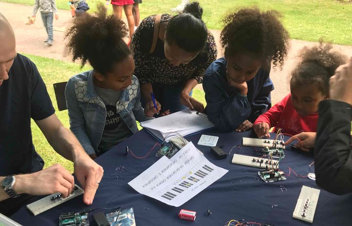 young people doing the synth keyboard challenge at switch on your happiness with imperial community engagement team from the Invention Rooms