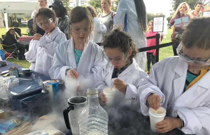 Kids making liquid nitrogen ice cream at the wormholt park summer fete with the team from the invention rooms 