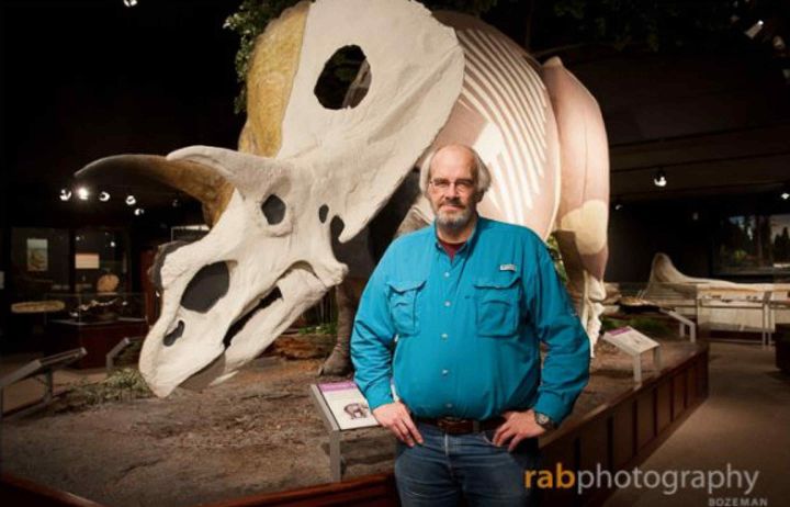 Jack Horner standing in front a replica of a triceratops