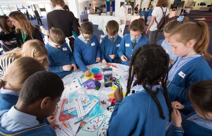 Students gathered around a table for an activity.