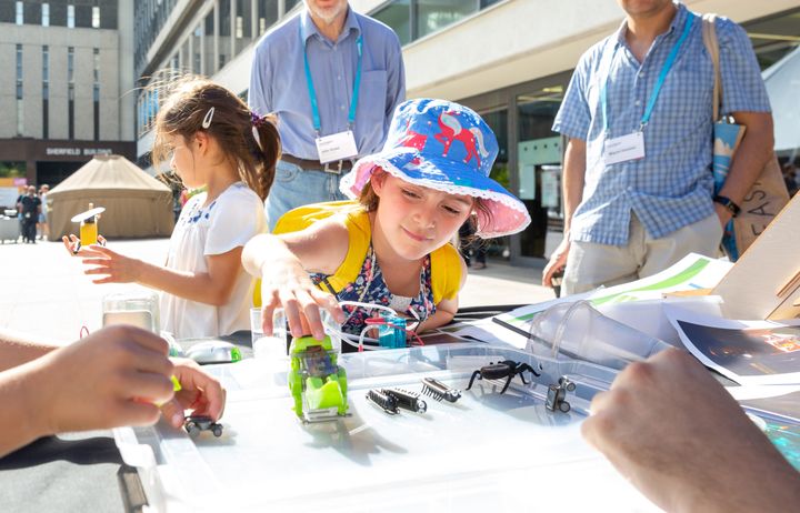 A young child interacts with a stall at the Festival.