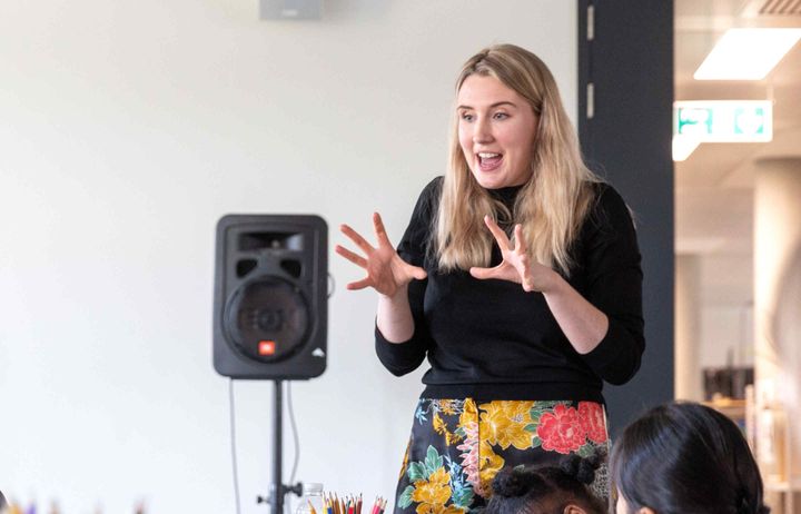 A volunteer gives a talk to students.