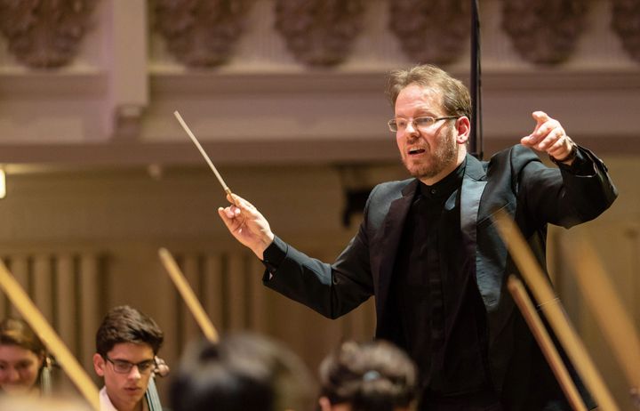 Oliver Gooch conducting an orchestra