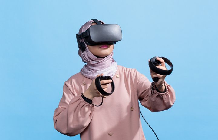 A photograph of a female student wearing a virtual reality headset