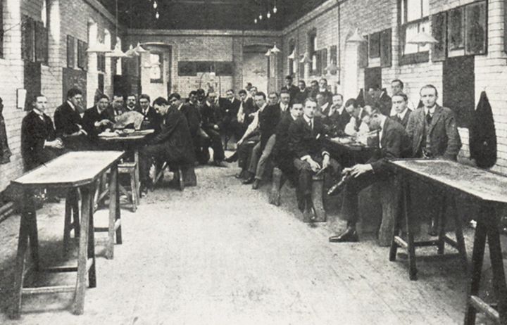 A black and white photo showing a class of male medical students in the dissecting room at Imperial in the early 20th century
