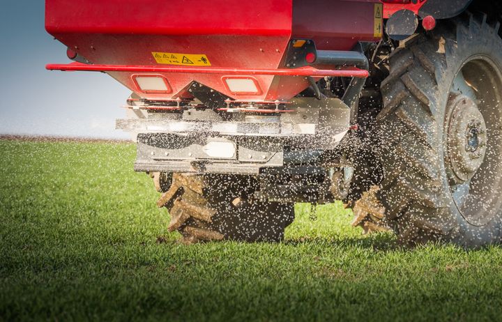 A tractor spreading fertiliser