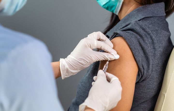 A woman being given a vaccine injection