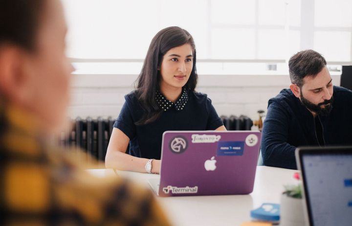 Young person in a group with a laptop