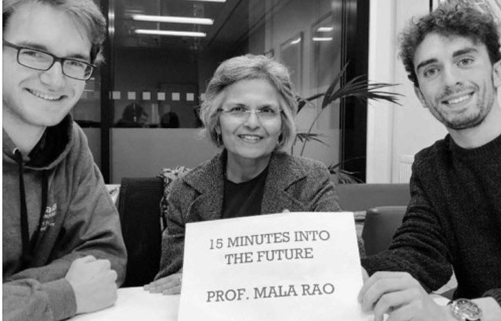 Erik and Carl with Professor Mala Rao holding up a sign saying 
