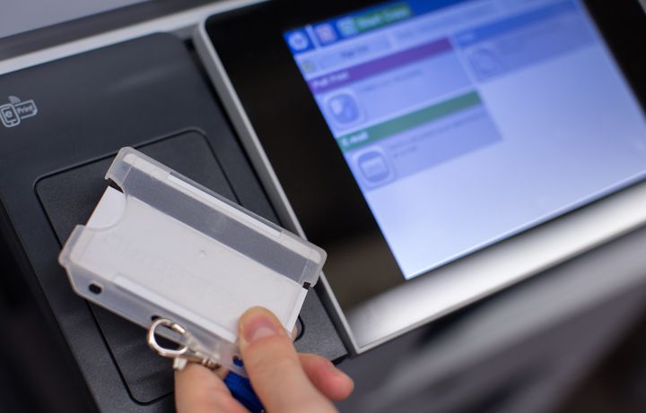 ID card being tapped on printer