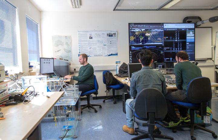 Researchers sitting in a computer systems lab