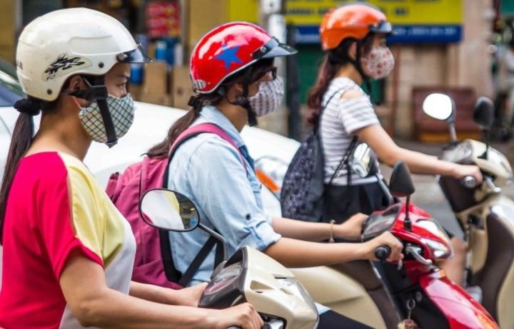People on scooters wearing face masks