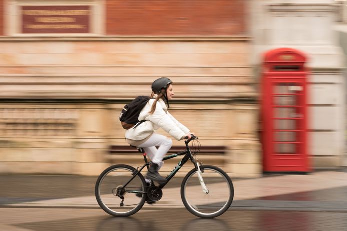 Student on bike riding down street