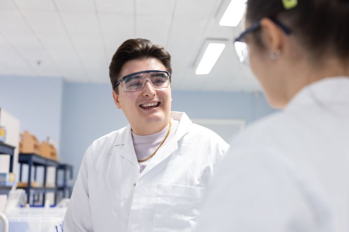 Two male students talking in a science lab