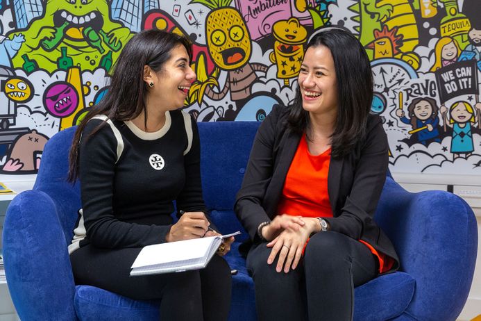 Two members of staff in conversation