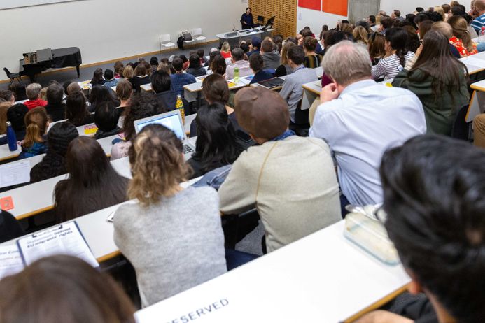 Looking over audience in lecture theatre listening to speaker at front