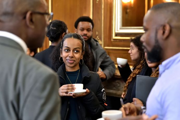 Group of people talking over conference refreshments