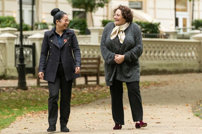 A patient and doctor walking in a park