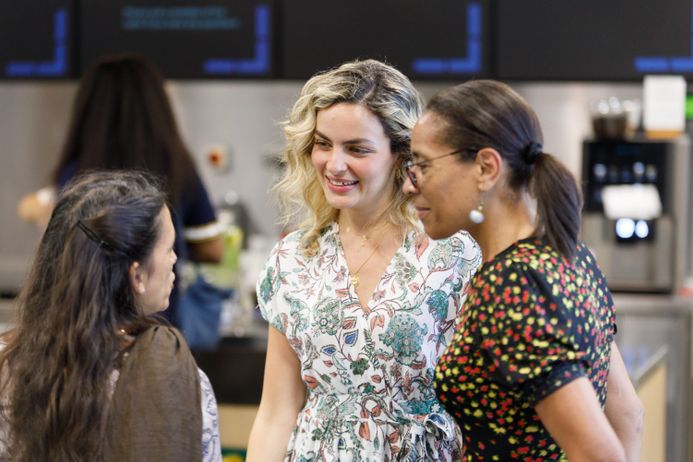 Three women talk to each other in The Invention Rooms