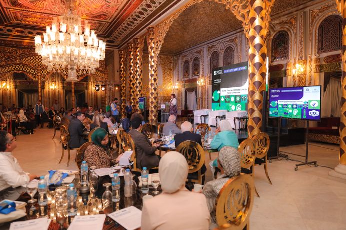 Groups of people seated at an event in an elaborate hall