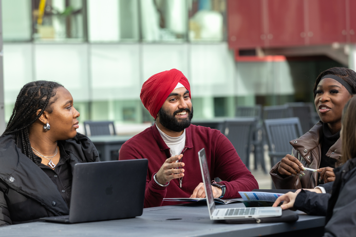 Image of students sitting at a table