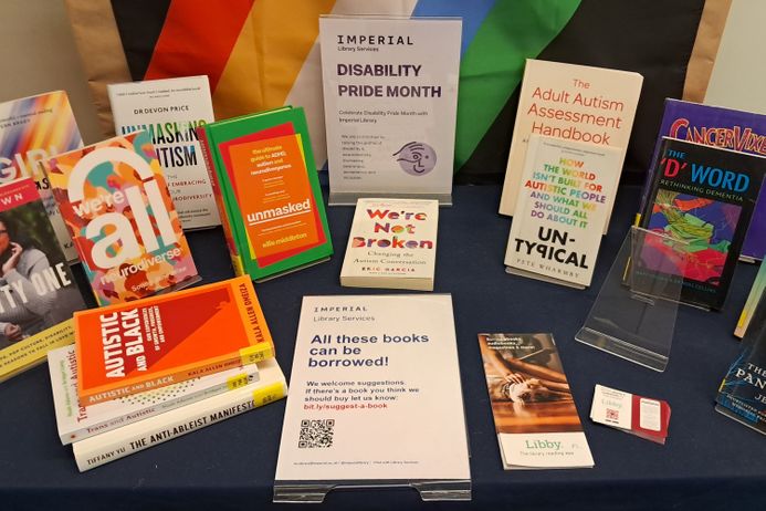 Books displayed on desk relating to disability with sign about borrowing