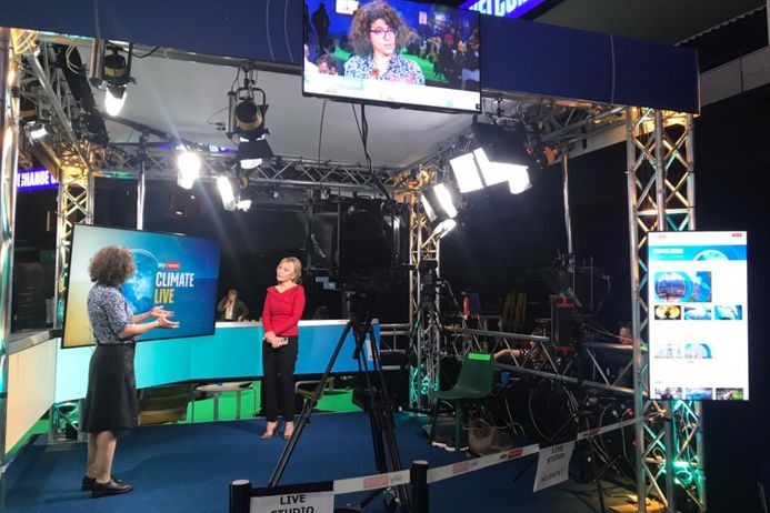 A view from behind the cameras, as Alyssa Gilbert is interviewed by a reporter at the climate summit