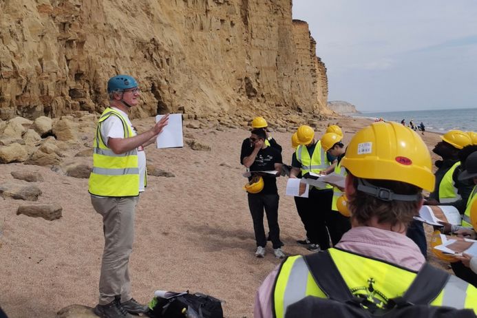 Students in front of rocks on a field trip in Dorset