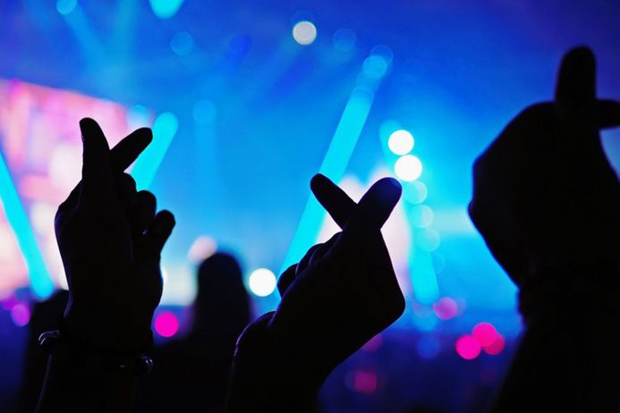 Hands in front of a bright stage background