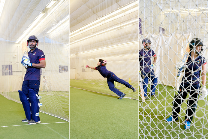 Students in batting cages practising cricket