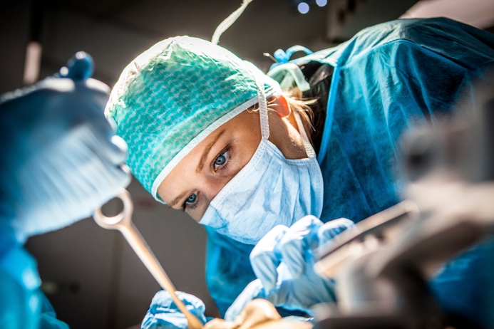 Female doctor with protective mask in surgery