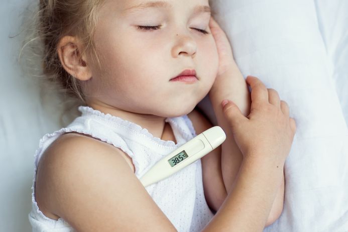 A picture of a child with a thermometer under her arm to take her temperature