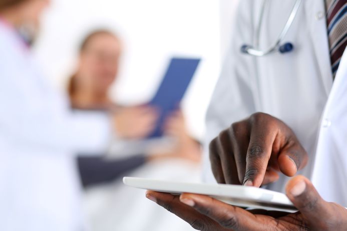 A picture of a doctor using a digital tablet