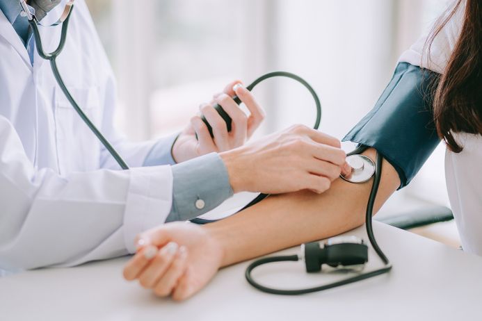 A picture of a doctor taking a patient's blood pressure