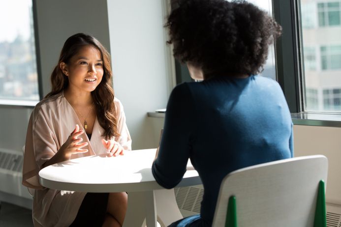 Two people sitting together having a meeting or conversation